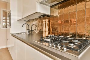 a-kitchen-with-a-stove-top-oven-and-a-sink-scaled