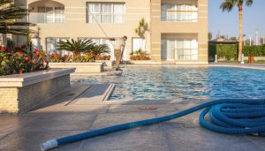 A man cleaning swimming pool