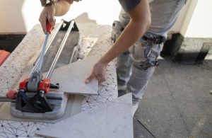 Worker cutting tiles